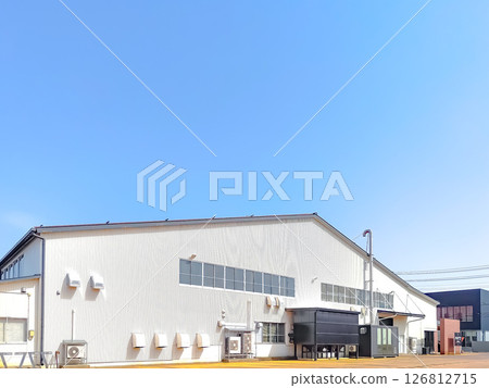 Factory with white exterior and blue sky Factory with white exterior and blue sky 126812715