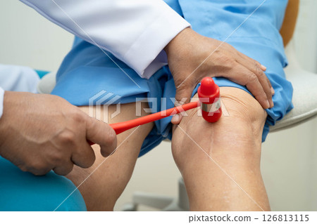 Asian doctor knock on knee reflex nerve for check and treatment senior patient in hospital. Asian doctor knock on knee reflex nerve for check and treatment senior patient in hospital. 126813115