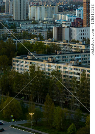 urban landscape with tall buildings and several trees, residential area, multi-storey buildings. 126813158