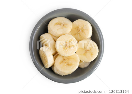 peeled banana pieces in ceramic bowl isolated on white background. Top view. Flat lay. 126813164