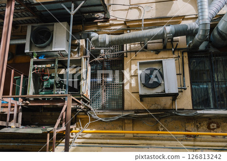 building with large air conditioner on wall. Ventilation air conditioning. cooling down in summer. 126813242