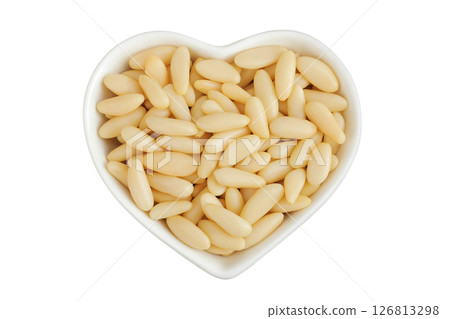 Shelled European pine nuts in ceramic bowl isolated on white background with full depth of field. Top view. Flat lay Shelled European pine nuts in ceramic bowl isolated on white background with full depth of field. Top view. Flat lay 126813298