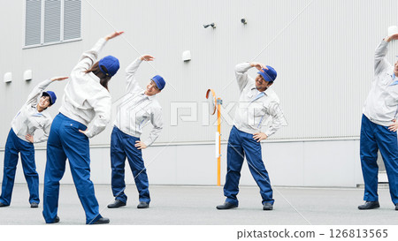 Group of workers doing exercises outdoors Group of workers doing exercises outdoors 126813565