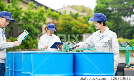 A group of workers inspecting drums 126813621