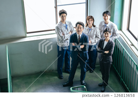 A group of company employees lined up indoors 126813658