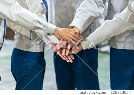 A group of workers forming a circle 126813694