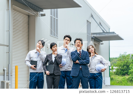 A group of company employees thinking in front of a building A group of company employees thinking in front of a building 126813715