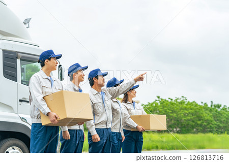 A group of delivery staff lined up in front of a truck 126813716