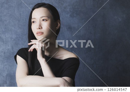 A woman wearing a black off-the-shoulder A woman wearing a black off-the-shoulder 126814547