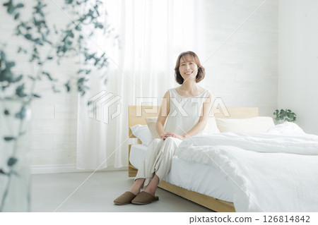 Senior woman waking up in bedroom 126814842
