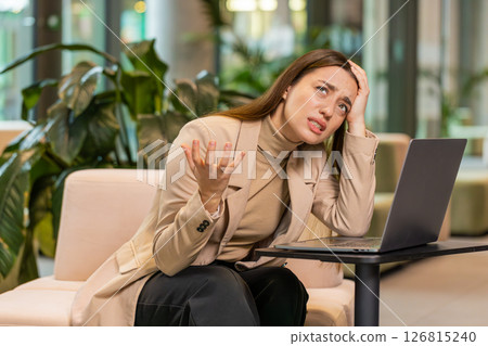 Caucasian businesswoman girl using laptop surprised by bad news, fortune loss, fail, lottery results 126815240