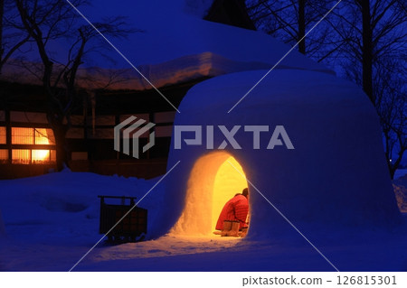 Snow-covered old house and snow igloos 126815301
