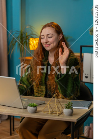 Businesswoman employee waves hand hi gesture greeting welcomes someone at camera online webinar 126815339