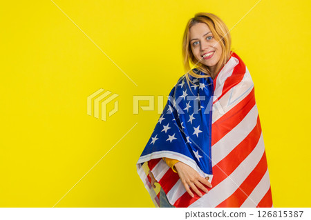 Blonde young woman waving and wrapping in American USA flag, celebrating, human rights and freedoms 126815387