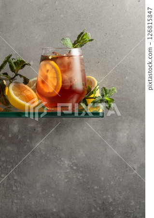 Iced tea with lemon and mint on the background of the grey concrete wall. 126815847