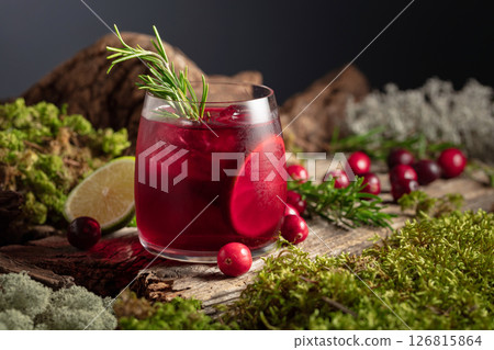 Refreshing cranberry hard seltzer with lime, rosemary, and ice. 126815864