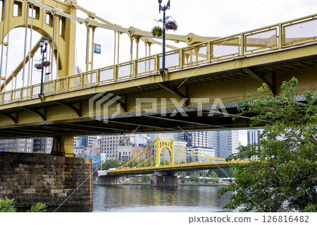 Looking up at Golden Bridges Spaning Across River With the City of Pittsburgh Skyline in Background 126816482