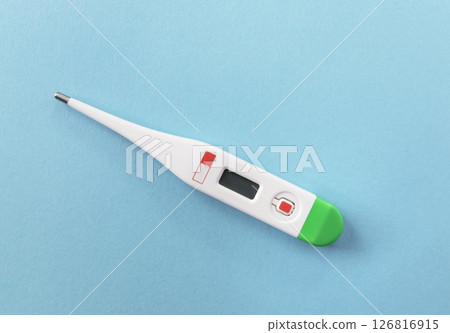 White digital thermometer for temperature measurement on beige background. 126816915