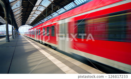 Trains Speeding Past a Busy Platform in a Railway Station During Daylight Hours Trains Speeding Past a Busy Platform in a Railway Station During Daylight Hours 126817233