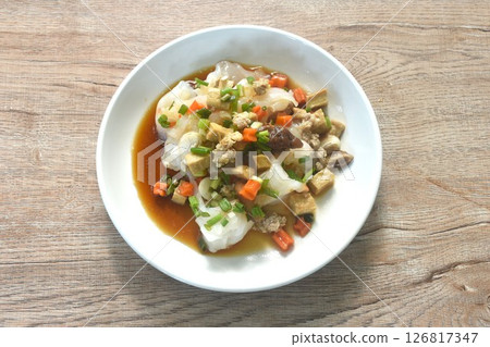 steamed large rice noodles topping chop pork and dice tofu with carrot dressing black soy sauce on plate steamed large rice noodles topping chop pork and dice tofu with carrot dressing black soy sauce on plate 126817347