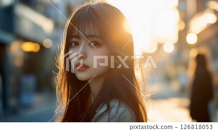 Portrait of a woman in the setting sun 126818053