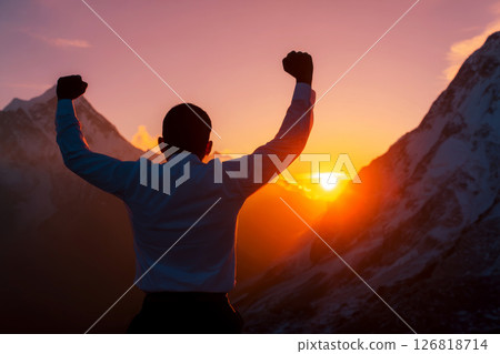 businessman rise hand up on top of mountain and sunset sky background. 126818714