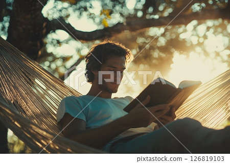 man reading book in hammock with soft light, relaxed mood, summer vibes, stock photo style, realistic, 126819103