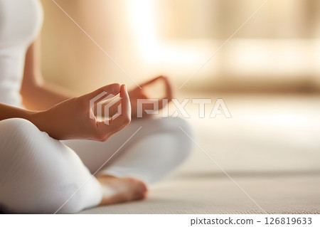 Woman practicing mindfulness meditation in her living room soft daylight relaxing mood comfortable space 126819633