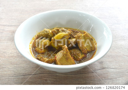 spicy fried pork bone with yellow curry and basil leaf Thai southern food on bowl  126820174