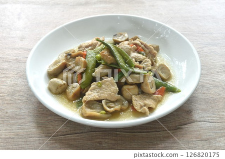 stir fried green pea and straw mushroom with pork in soybean sauce on plate 126820175