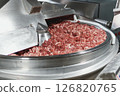 Processing of production minced meat in industrial meat grinder, close up. 126820765