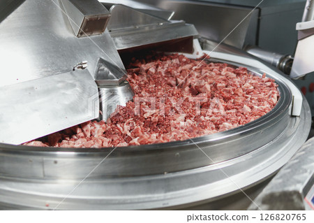 Processing of production minced meat in industrial meat grinder, close up. 126820765