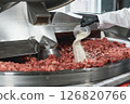 Processing of production minced meat in industrial meat grinder, close up. 126820766