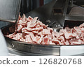Processing of production minced meat in industrial meat grinder, close up. 126820768