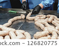 Close up of sausages production process at the meat factory. 126820775