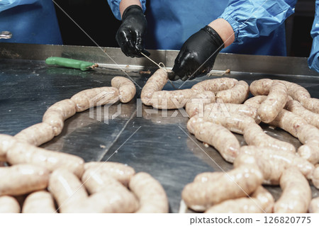 Close up of sausages production process at the meat factory. 126820775