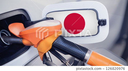 The Japanese flag on the lid of the gas tank of a car at a gas station in close-up. High or low gasoline prices at Japan gas stations. Gasoline prices are rising due to a shortage of diesel fuel 126820976