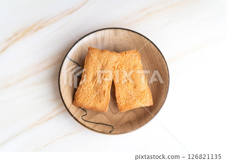 Freshly baked financiers on a plate① 126821135
