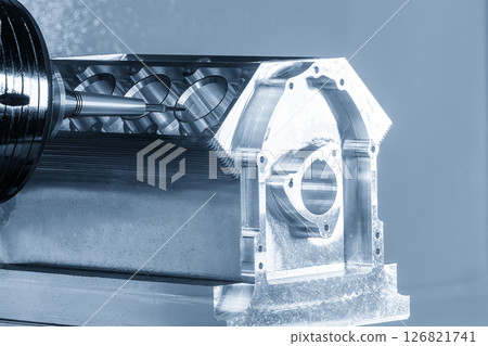 The 5-axis CNC milling machine cutting the aluminum engine block by solid ball nose end mill tool in the light blue scene. 126821741