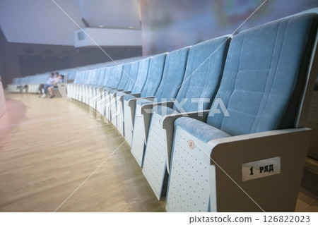 A row of empty soft chairs in the auditorium. 126822023