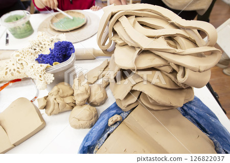 Clay master class. A large piece of clay for making pottery. Potter's work table. 126822037