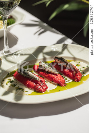 Portion of baked pepper appetizer with small fish Portion of baked pepper appetizer with small fish 126822764