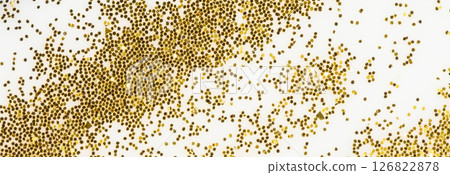 Festive or glamorous background. Gold sparkles scattered on a white background. Festive or glamorous background. Gold sparkles scattered on a white background. 126822878