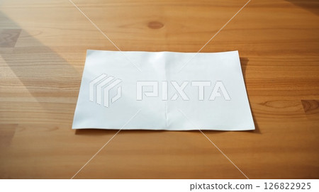 Art photo of desk with paper. Candlelight warms the wood, smooth texture. 126822925