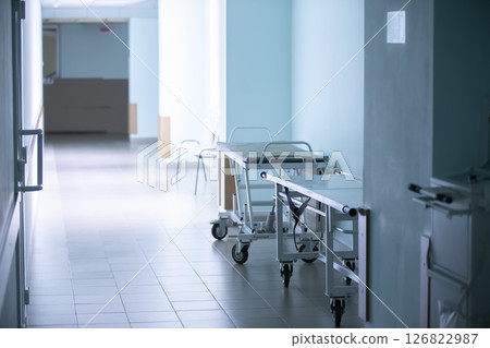 Empty hospital corridor with medical gurneys. Empty hospital corridor with medical gurneys. 126822987