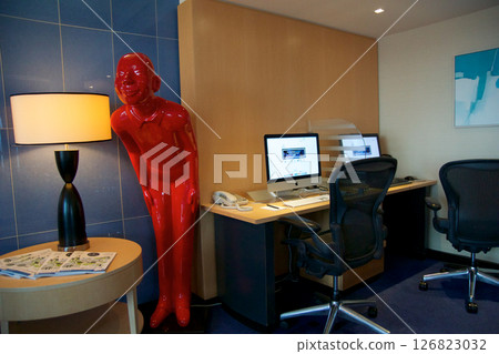 Vienna, Austria, April 29, 2017: Business Corner with Computers and Life-Size Red Figure 126823032