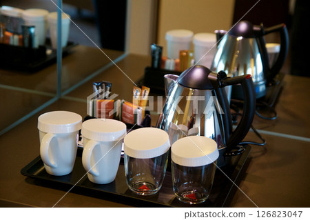 Mainz, Germany, July 8, 2017: Hotel Room Coffee and Tea Station with Porcelain Cups and Glasses Mainz, Germany, July 8, 2017: Hotel Room Coffee and Tea Station with Porcelain Cups and Glasses 126823047