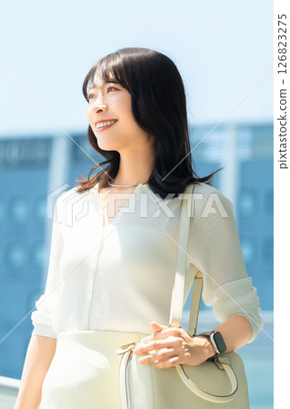 Woman/businesswoman walking in an office district Woman/businesswoman walking in an office district 126823275