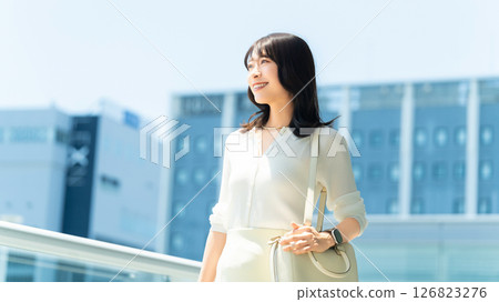 Woman/businesswoman walking in an office district Woman/businesswoman walking in an office district 126823276