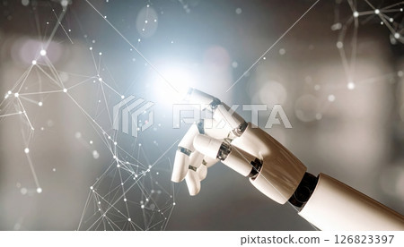 Close-up of a robotic hand interacting with digital technology representing artificial ligence and future innovation 126823397
